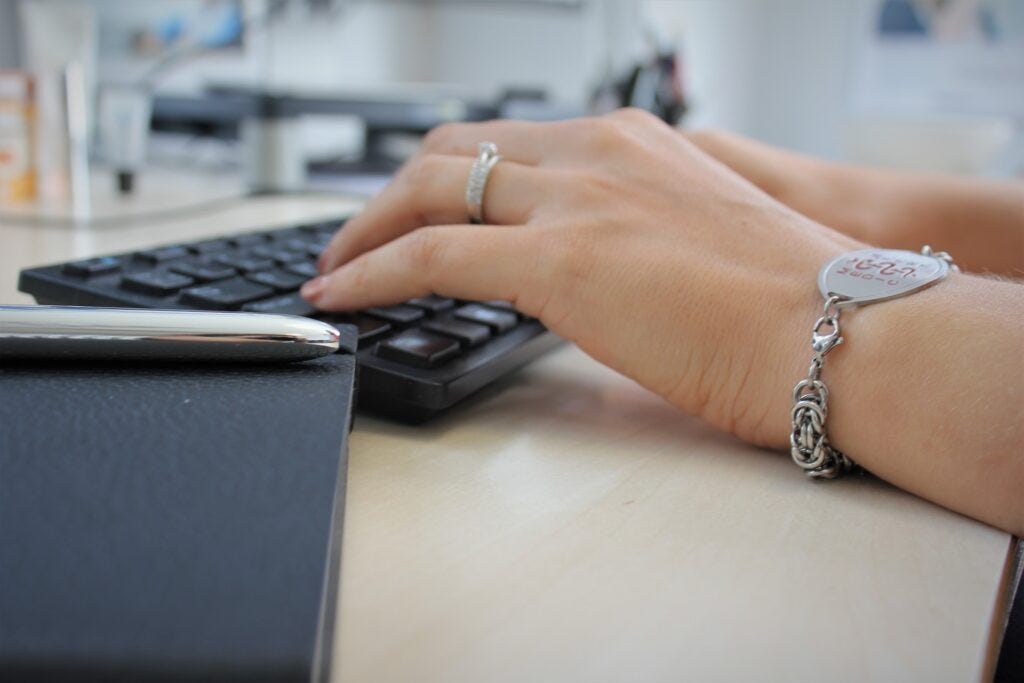 women typing at receptionist desk
